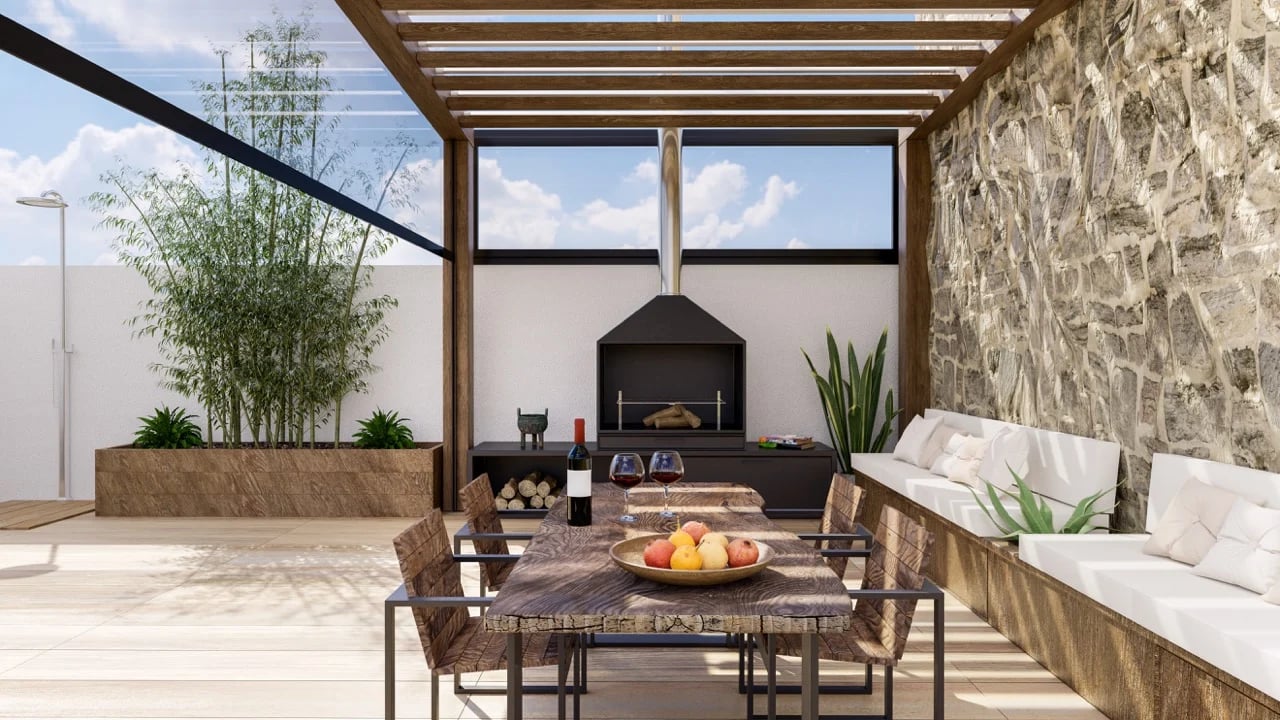 picture of a nice patio with an overhead table with wine and black fireplace in the background
